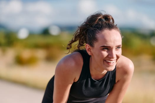 A woman takes a moment to rest and recuperate after an intense run, finding solace and rejuvenation in the tranquility of her surroundings.