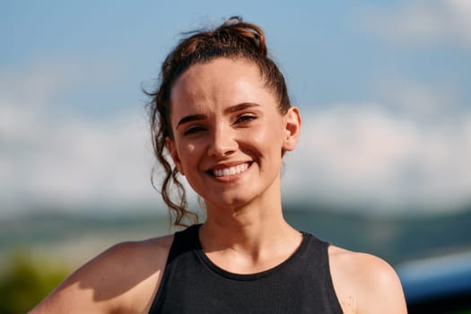 In a captivating close up portrait, an athletic woman exudes confidence and happiness, her wide smile radiating infectious joy and positivity.