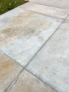 A close-up view of a concrete driveway showcasing repaired joints and cracks. The fixed areas demonstrate effective maintenance, enhancing the driveways durability and appearance.