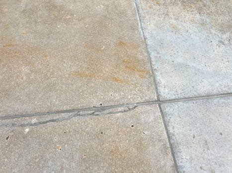 A close-up view of a concrete driveway showcasing repaired joints and cracks. The fixed areas demonstrate effective maintenance, enhancing the driveways durability and appearance.