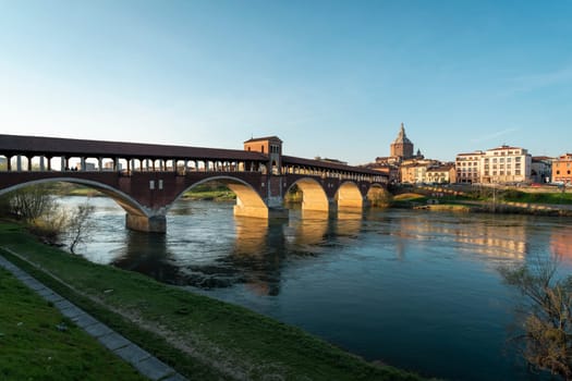 Landscape of Ponte Coperto (covered bridge) and Duomo di Pavia (Pavia Cathedral) in Pavia at sunny day, Lombardy, italy.