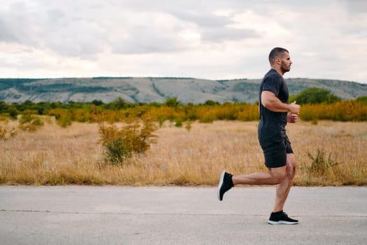 An athletic man jogs under the sun, conditioning his body for life's extreme challenges, exuding determination and strength in his preparation for the journey ahead