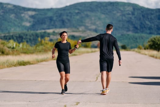 A couple embraces a healthy lifestyle by running together on a sunny day, exemplifying dedication to fitness and wellness in their partnership