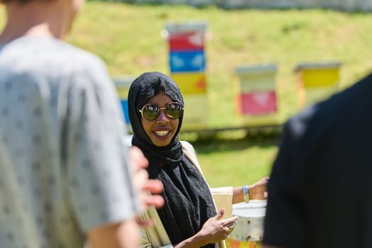 A diverse group of young friends and entrepreneurs explore small honey production businesses in the natural setting of the countryside