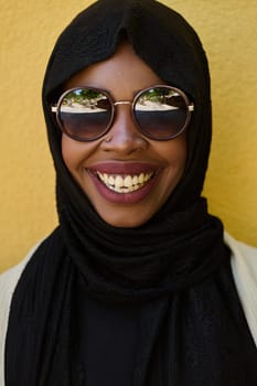 A striking close up photograph capturing the beauty and cultural identity of a Middle Eastern Muslim woman, set against a vibrant yellow backdrop