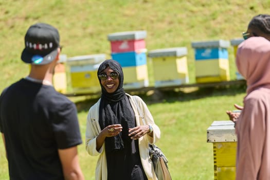 A diverse group of young friends and entrepreneurs explore small honey production businesses in the natural setting of the countryside