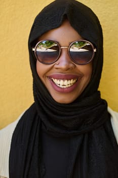 A striking close up photograph capturing the beauty and cultural identity of a Middle Eastern Muslim woman, set against a vibrant yellow backdrop