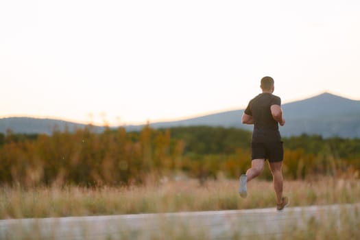 An athletic man jogs under the sun, conditioning his body for life's extreme challenges, exuding determination and strength in his preparation for the journey ahead