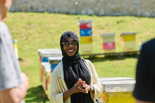 A diverse group of young friends and entrepreneurs explore small honey production businesses in the natural setting of the countryside