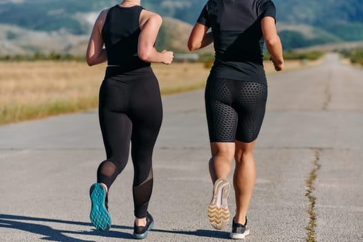 Two friends jog side by side on a sunny day, strengthening their bodies for life's extreme challenges, embodying the power of friendship and determination