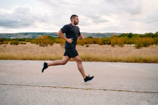 An athletic man jogs under the sun, conditioning his body for life's extreme challenges, exuding determination and strength in his preparation for the journey ahead