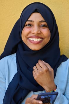 A close-up portrait captures the engagement of a Middle Eastern teenage Muslim girl in her digital world, as she uses a smartphone with focused attention