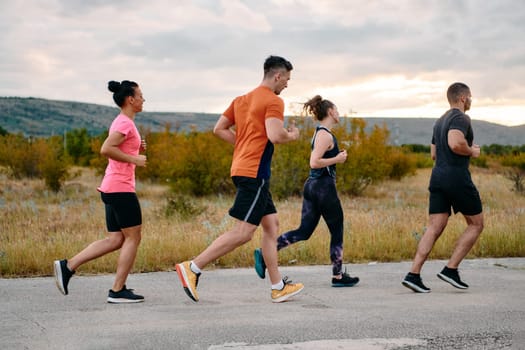 A professional athletic team as they train rigorously, running towards peak performance in preparation for an upcoming marathon.