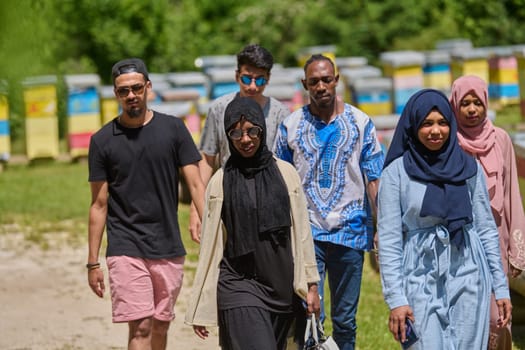 A diverse group of young friends and entrepreneurs explore small honey production businesses in the natural setting of the countryside