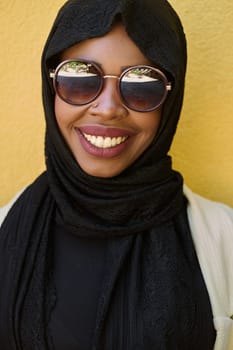 A striking close up photograph capturing the beauty and cultural identity of a Middle Eastern Muslim woman, set against a vibrant yellow backdrop