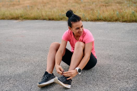 An athletic woman prepares herself for a morning run, embodying dedication and determination in her fitness routine