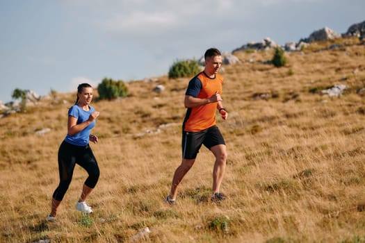 Couple conquer challenging mountain trails during an invigorating morning run.