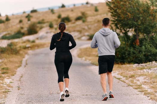 Couple conquer challenging mountain trails during an invigorating morning run.