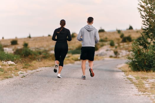 Couple conquer challenging mountain trails during an invigorating morning run.