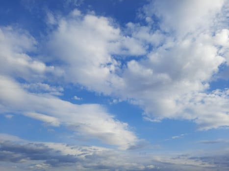 Beauty cloud against a blue sky background. Sky slouds. Blue sky with cloudy weather, nature cloud. White clouds, blue sky and sun. High quality photo