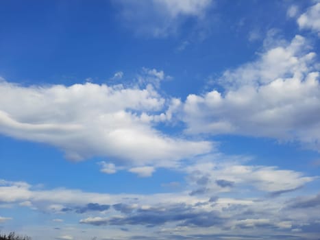 Beauty cloud against a blue sky background. Sky slouds. Blue sky with cloudy weather, nature cloud. White clouds, blue sky and sun. High quality photo