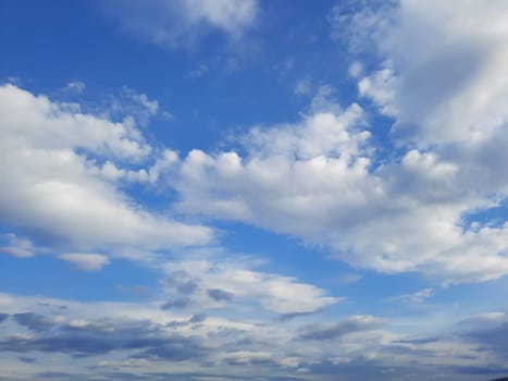 Beauty cloud against a blue sky background. Sky slouds. Blue sky with cloudy weather, nature cloud. White clouds, blue sky and sun. High quality photo