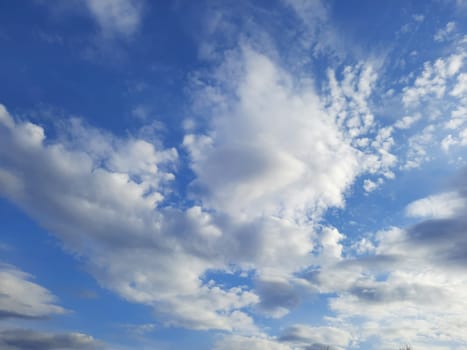 Beauty cloud against a blue sky background. Sky slouds. Blue sky with cloudy weather, nature cloud. White clouds, blue sky and sun. High quality photo
