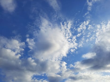 Beauty cloud against a blue sky background. Sky slouds. Blue sky with cloudy weather, nature cloud. White clouds, blue sky and sun. High quality photo