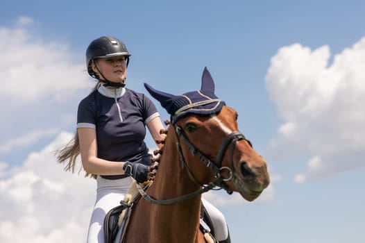 Portrait of a girl jockey riding a horse