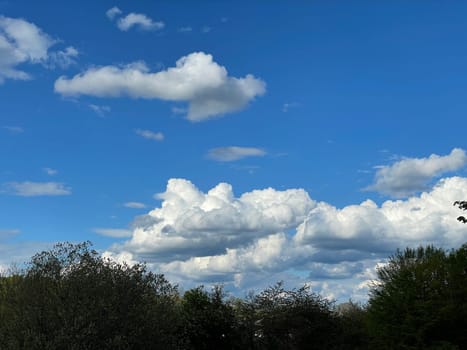 Beauty cloud against a blue sky background. Sky slouds. Blue sky with cloudy weather, nature cloud. White clouds, blue sky and sun. High quality photo