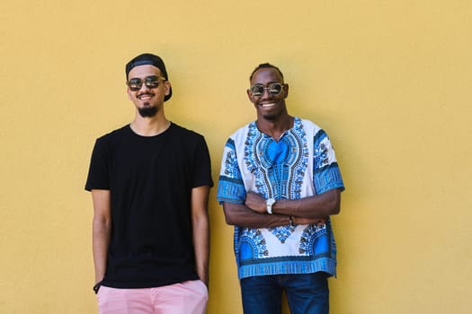 A depiction of camaraderie and cultural diversity two male friends, one an African American teenager dressed in Sudanese traditional attire, leaning against a vibrant yellow wall