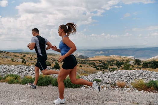 Couple conquer challenging mountain trails during an invigorating morning run.