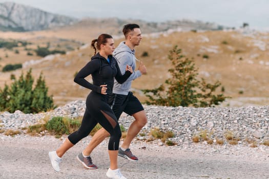 Couple conquer challenging mountain trails during an invigorating morning run.