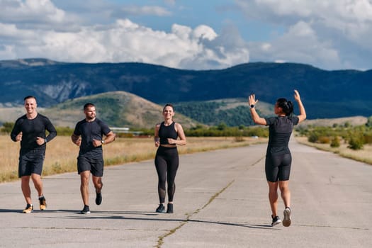 A professional athletic team as they train rigorously, running towards peak performance in preparation for an upcoming marathon.