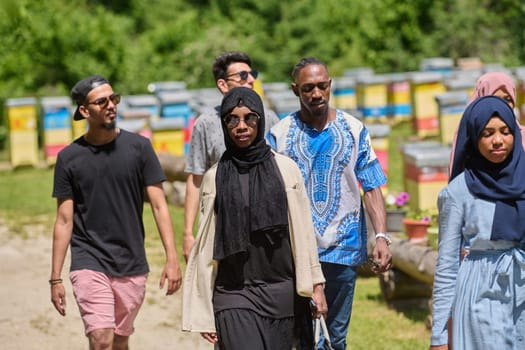 A diverse group of young friends and entrepreneurs explore small honey production businesses in the natural setting of the countryside