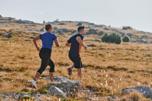 Couple conquer challenging mountain trails during an invigorating morning run.