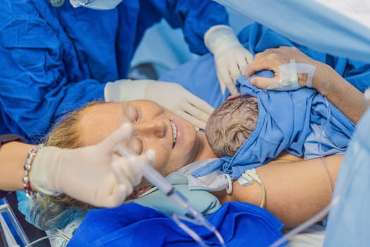 Baby on mother's chest immediately after birth in a hospital. The mother and newborn share a tender moment, emphasizing the bond and emotional connection. The medical staff ensures a safe and caring environment.