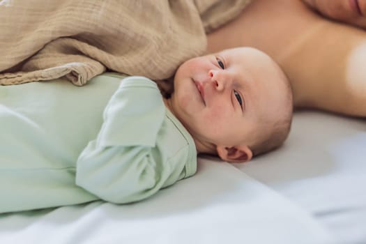 A baby lies with the mother after childbirth, resting peacefully. The serene moment captures the bond between mother and child as they begin their journey together. The hospital environment ensures a safe and comforting space for this intimate interaction.