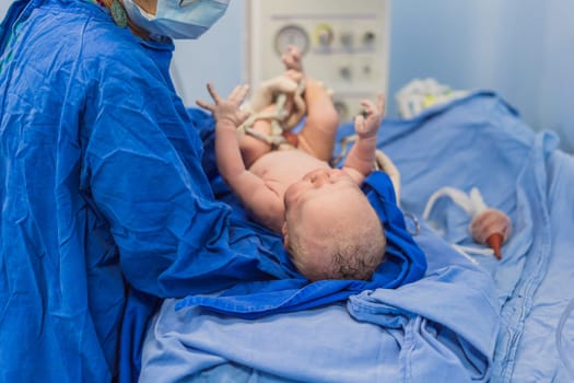 A nurse caring for a newborn baby in a hospital setting. The nurse provides gentle and attentive care, ensuring the baby's comfort and well-being.