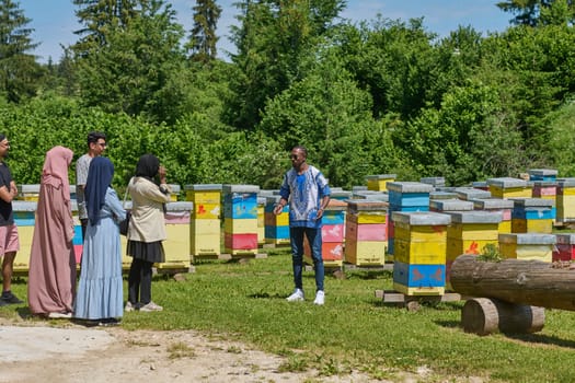 A diverse group of young friends and entrepreneurs explore small honey production businesses in the natural setting of the countryside