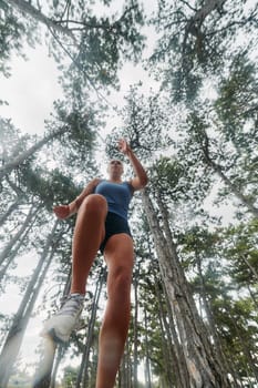 A brave woman traverses through the forest, fearlessly leaping over dangerous obstacles with determination and agility, showcasing her adventurous spirit and athletic prowess.