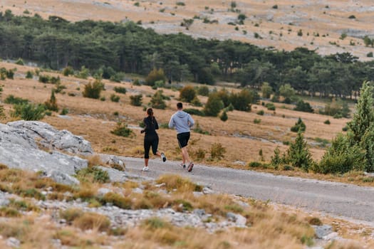 Couple conquer challenging mountain trails during an invigorating morning run.