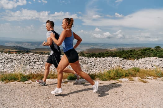 Couple conquer challenging mountain trails during an invigorating morning run.