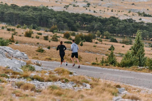 Couple conquer challenging mountain trails during an invigorating morning run.