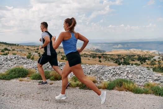 Couple conquer challenging mountain trails during an invigorating morning run.