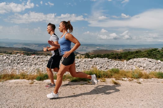 Couple conquer challenging mountain trails during an invigorating morning run.