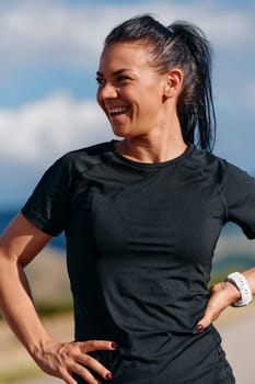 A woman takes a moment to rest and recuperate after an intense run, finding solace and rejuvenation in the tranquility of her surroundings.