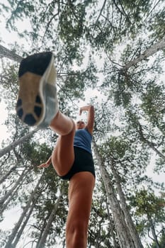 A brave woman traverses through the forest, fearlessly leaping over dangerous obstacles with determination and agility, showcasing her adventurous spirit and athletic prowess.