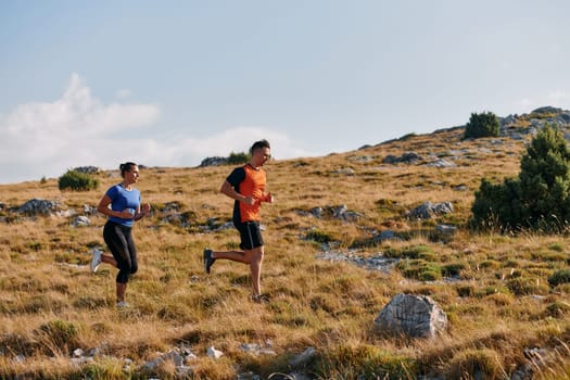 Couple conquer challenging mountain trails during an invigorating morning run.