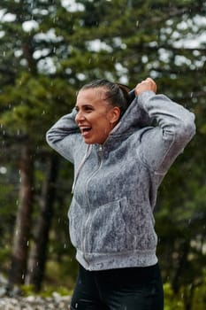 A stunning woman savors the tranquility of a rainy day after a rigorous run, finding solace and rejuvenation in the soothing rhythm of the falling rain.